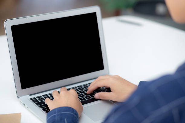 istock Young business man using laptop computer blank screen on desk at home, businessman work on notebook to internet online copy space for your text message, male typing keyboard, communication concept. 1357390169