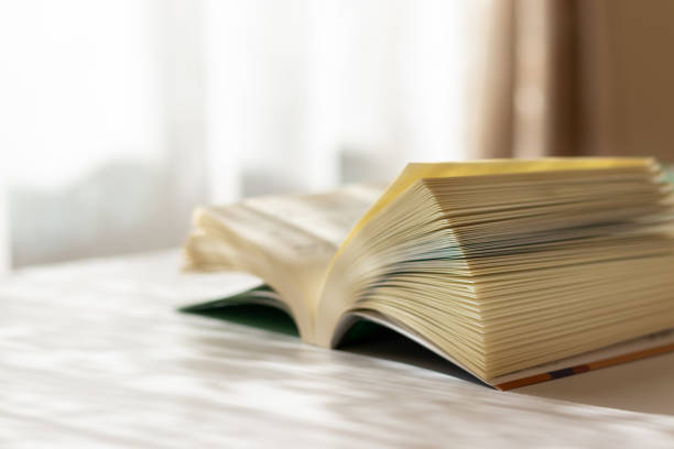 istock A book opened on the desk by the window 1357392643