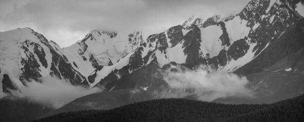 istock Black and white landscape. Snow-capped mountain peaks. 1357392885