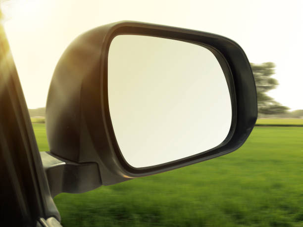 istock view mirrors in cars at the setting sun, blurred landscape 1357394969