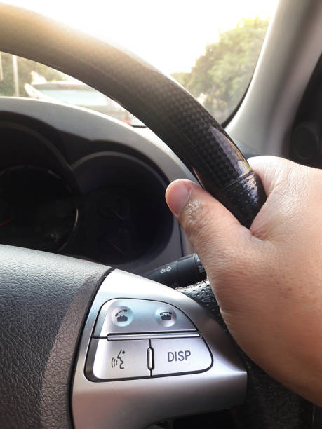 istock Turn the steering wheel while driving with warm light vintage. Car interior detail 1357395579