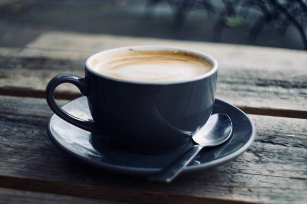 istock Cup of coffee on a rustic wooden table 1357395884