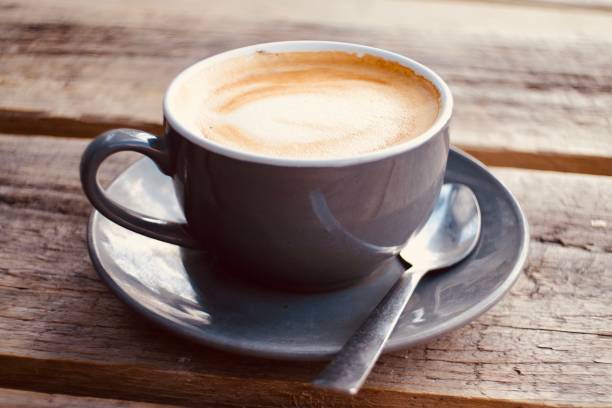 istock Cup of coffee on a rustic wooden table 1357395886