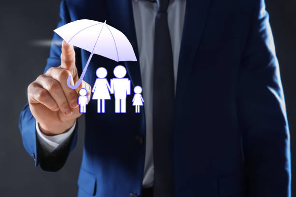 istock Insurance concept - umbrella demonstrating protection. Man using virtual screen with illustrations, closeup 1357396554