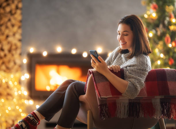 istock woman near Christmas tree 1357396673