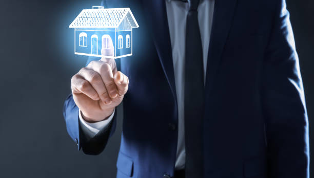 istock Real estate agent touching house illustration on virtual screen against dark background, closeup 1357396925