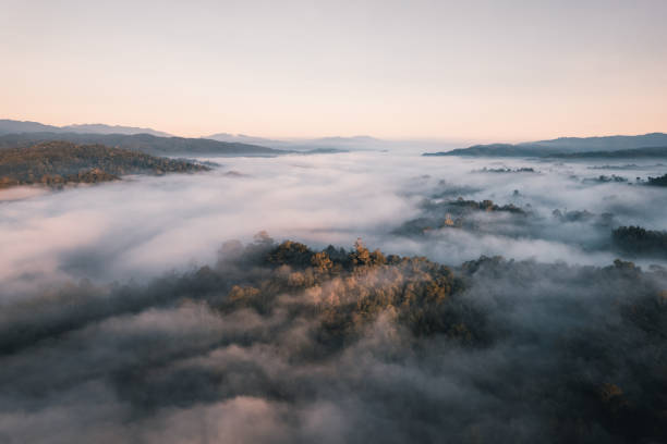 istock Flying above the clouds sunrise and fog 1357399280