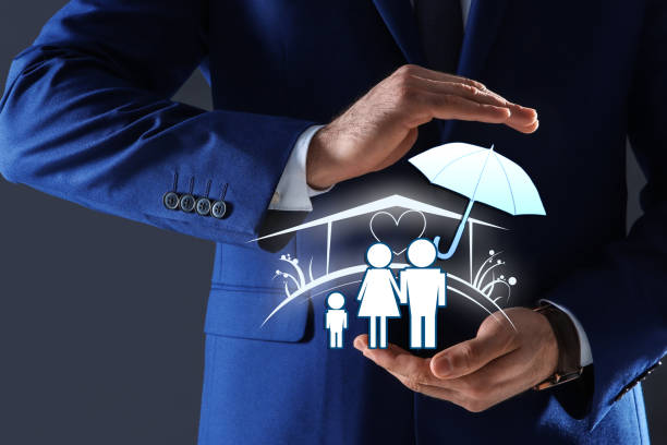 istock Insurance concept - umbrella demonstrating protection. Man with illustrations on dark background, closeup 1357399294