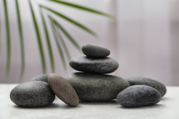 istock Spa stones on white table indoors. Zen and harmony 1357399580