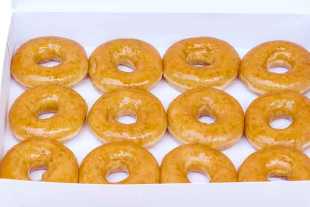 istock Donuts in white paper box isolated on white background , clipping path 1357399606