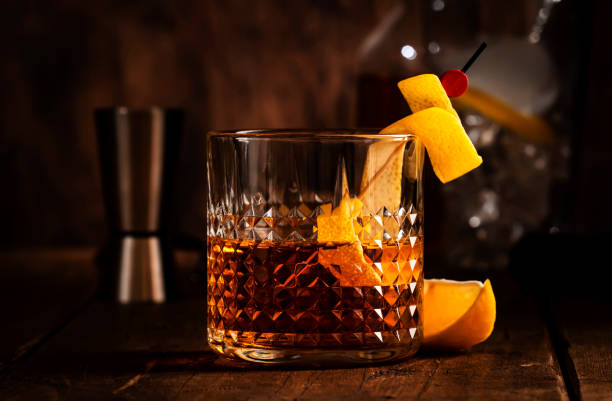 istock Sazerac, classic alcoholic cocktail with cognac, bourbon, absinthe, bitters, sugar and lemon zest. Old wooden background with copy space 1357401644