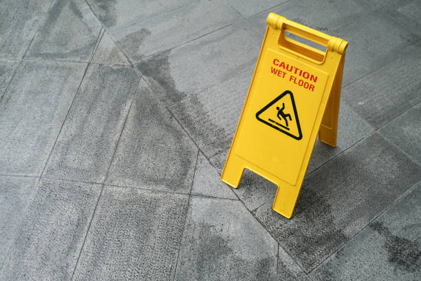 istock Yellow Caution slippery wet floor sign on the wet ground 1357401807