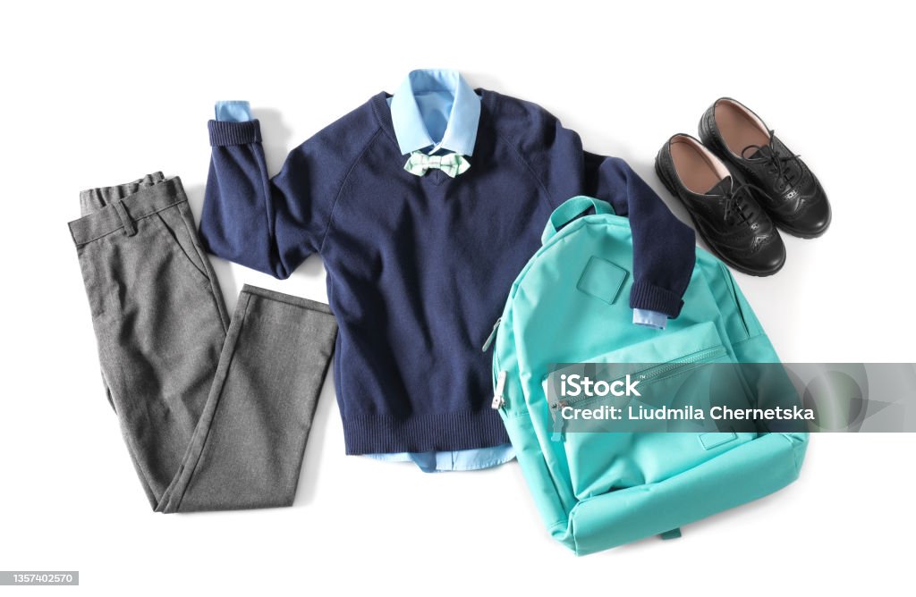 Stylish school uniform for boy and backpack on white background, top view School Uniform Stock Photo