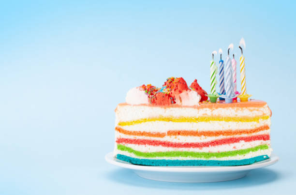 istock Birthday or holiday cake with burning candles on a blue 1357402917