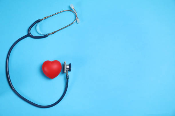 istock Stethoscope and red heart on light blue background, flat lay. Space for text 1357403576