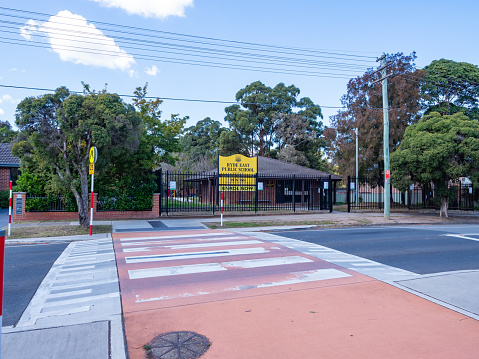 Sydney NSW Australia - September 28th 2020 - School Facade and Zebra Crossing on a Cloudy Spring Afternoon