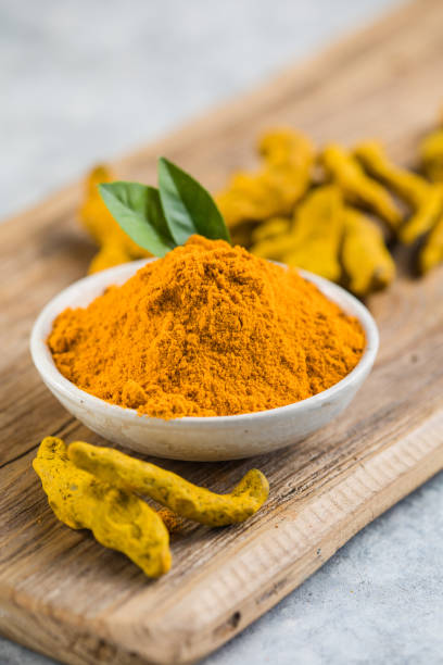 istock Indian turmeric powder and root. Turmeric spice. 1357407464