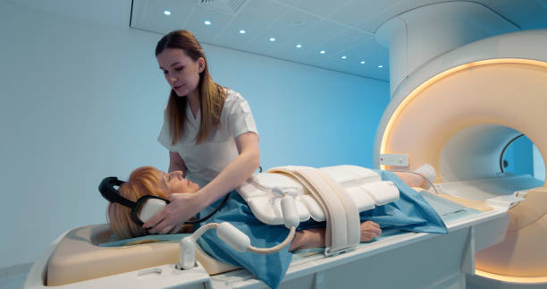 istock Female radiologist preparing her patient before MRI scan 1357407551