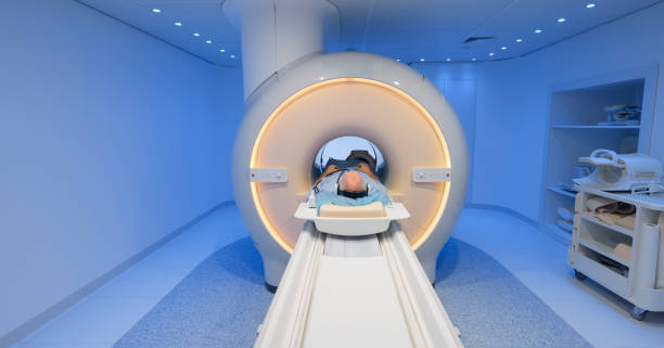 istock Male patient being slide into MRI scanner 1357407556