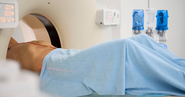 istock Male patient being slide into CAT scanner 1357407559