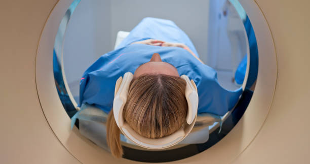 istock Mature female patient being slide into CAT scanner 1357407618
