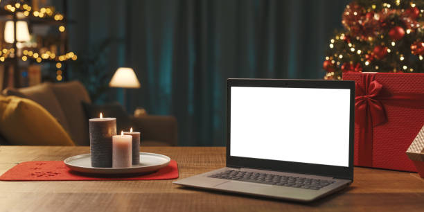 istock Laptop with blank screen, gifts and Christmas tree 1357407681