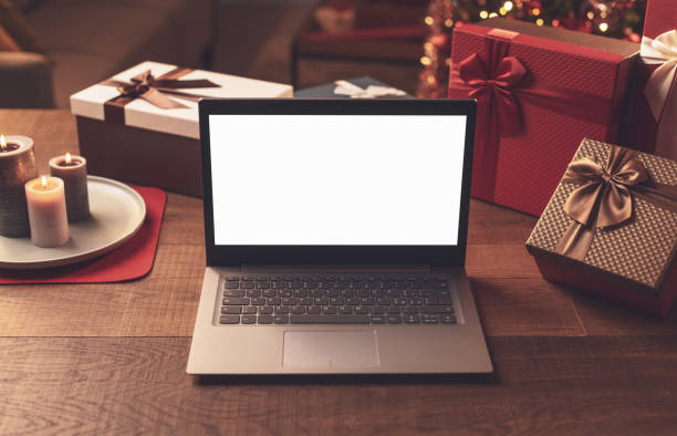 istock Laptop with blank screen and Christmas gifts 1357407842