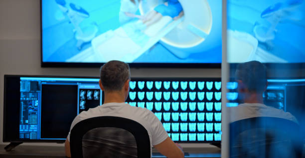 istock Male radiologist looking at the MRI scans on the computer 1357408052