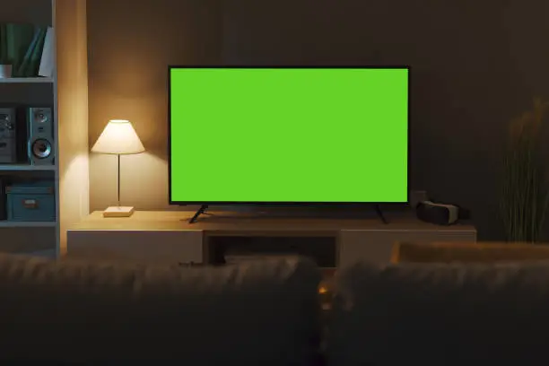 Television with horizontal green screen in the living room, entertainment and technology concept