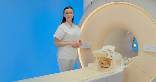 istock Female radiologist standing beside MRI scanner 1357410740