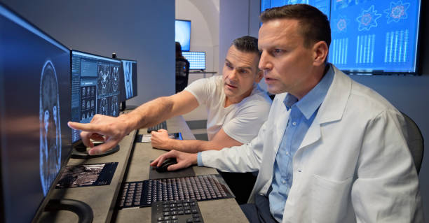 istock Male radiologists analysing MRI scans on their computers 1357410958