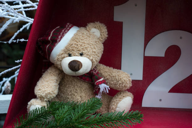 istock christmas teddy bear sitting in the street 1357411392