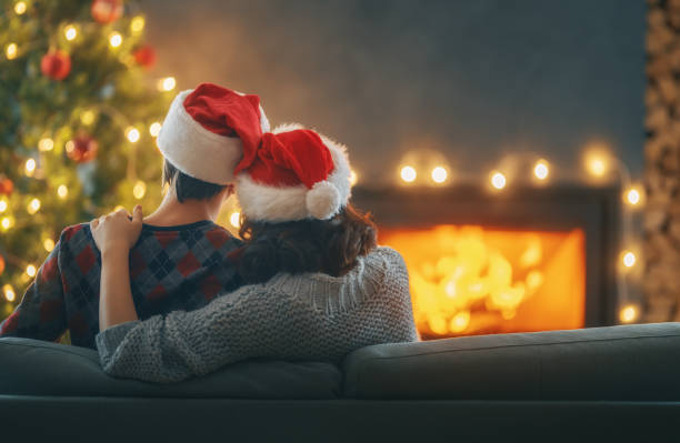 istock couple relaxing near Christmas tree 1357413515
