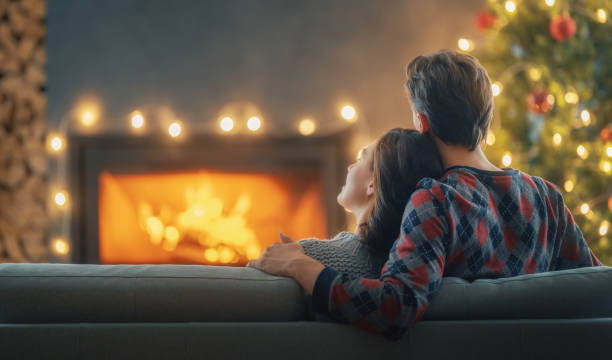 istock couple relaxing near Christmas tree 1357413559