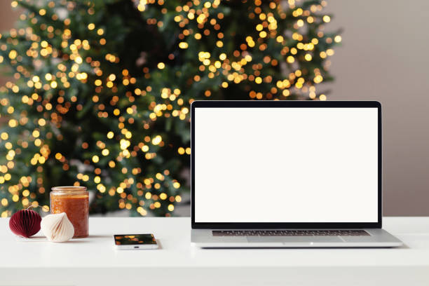 istock Place of work during Christmas time. Laptop with blank empty screen at home desk 1357413770