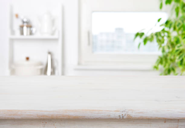 istock Wood table on blur kitchen window background for product display 1357413771