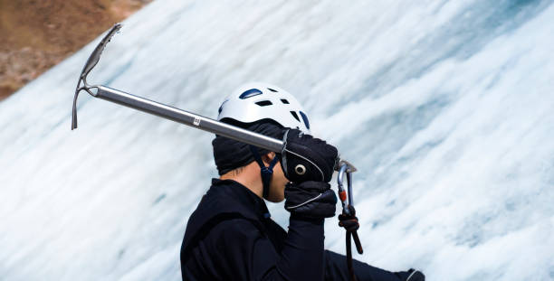el hombre está escalando con piolet en el glaciar. - ski insurance fotografías e imágenes de stock