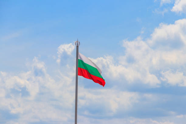 istock Waving flag of Bulgaria against blue sky 1357417080