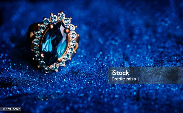Closeup Of Luxury Wedding Ring In Dark Blue Glitter Background Stock Photo - Download Image Now