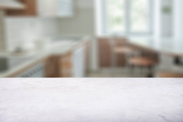 istock White marble countertop with luxury blurred kitchen background. Food product display table top with bokeh backdrop. 1357417490