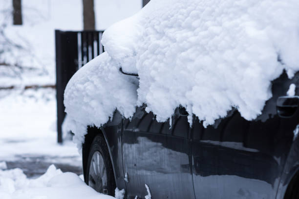 auto unter schneeschichten im vorgarten des hauses - snowpack stock-fotos und bilder