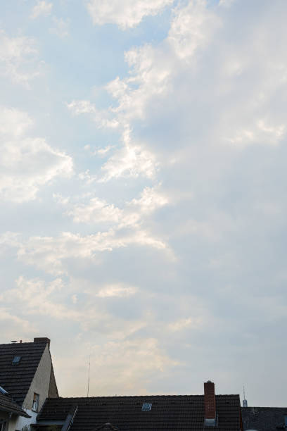 Dramatic clouds and blue sky over the roofs