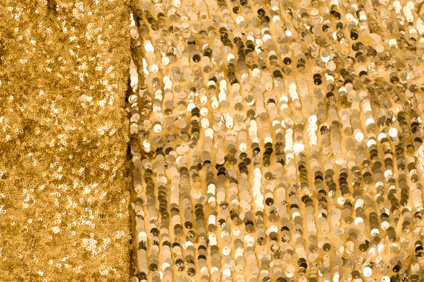 istock Shiny and glittering, golden fabrics with sequins. Abstract background. Events, celebrations, Christmas, New Year. Trendy backdrop. 1357422971