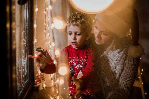 istock Little boy draws on a window in the winter 1357424264
