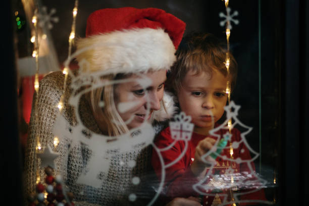 istock Little boy draws on a window in the winter 1357425147