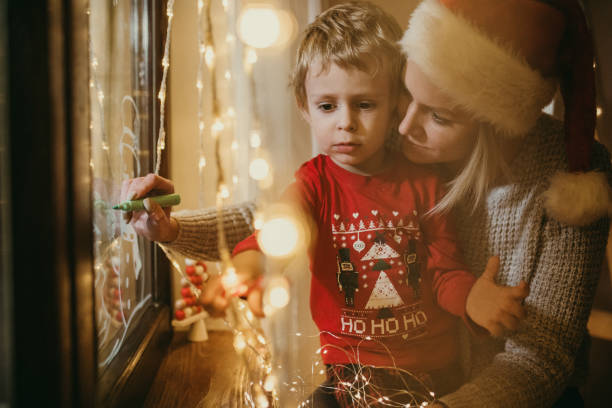 istock Little boy draws on a window in the winter 1357425233