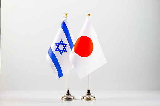 State flags of Israel and Japan on a light background.