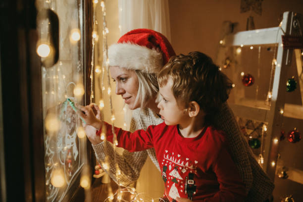 istock Little boy draws on a window in the winter 1357425740