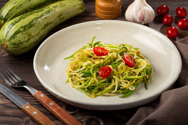 istock Zucchini spaghetti with tomatoes in garlic and oil. 1357425836