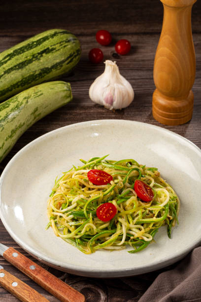 istock Zucchini spaghetti with tomatoes in garlic and oil. 1357425839